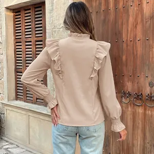 Elegant beige long sleeve blouse featuring romantic ruffle details and stand collar