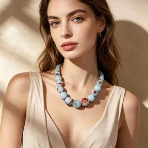 Detailed view of an ethnic style Jingdezhen ceramic bead necklace worn by a model