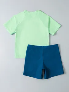 Two-piece kids swimwear set with mint green short sleeve top and navy blue shorts
