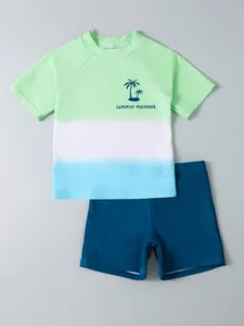 Kids boy's two-piece swimwear set featuring gradient short sleeve top and navy shorts