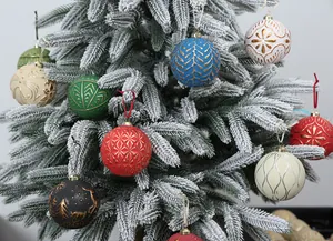 Detailed view of 8cm painted and electroplated Christmas ball ornaments on a snowy tree