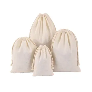 Set of four minimalist cream cotton drawstring bags for jewelry packaging and storage.
