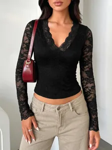 Detailed view of elegant black floral lace fabric on a V-neck long-sleeve top for women