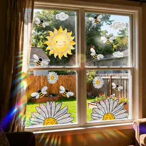 Rainbow prism window stickers with sun and bee designs reflecting colorful light on glass.