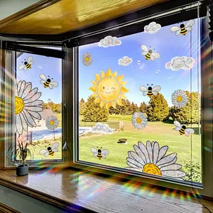 Rainbow sun and bee window stickers creating prismatic light effects on a wooden sill