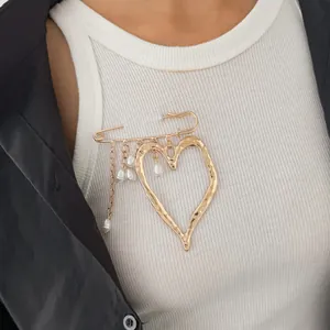 Close-up detail of a French style lava heart alloy brooch with elegant pearl tassels