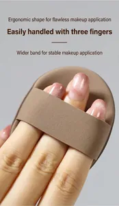 Close-up of a soft oval makeup puff held with three fingers for precise application
