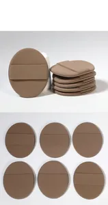Close-up detail of seven oval brown makeup sponges showing soft texture