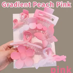Detailed view of matte gradient pink hair claw clip set featuring flower and butterfly shapes