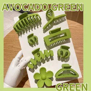 Close-up view of avocado green matte plastic hair claw clips in various shapes