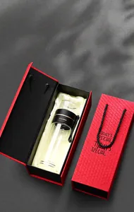 Elegant double-walled glass tea infuser bottle inside a premium red gift box set.