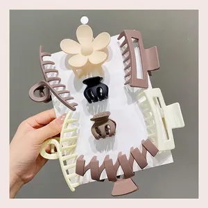 Detail showing a variety of matte hair claw clips in earth tones on a display card