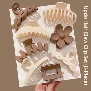 Set of 8 matte hair claw clips in earth tones including flower and wave shapes.