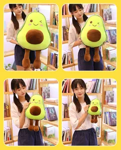 Four different sizes of cute avocado plush toys held by a model in a library