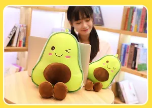 Adorable avocado plush pillows in two sizes showcased in a cozy indoor home office.
