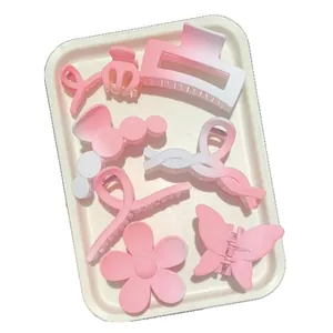 Set of elegant pink and white gradient hair claw clips in various stylish shapes