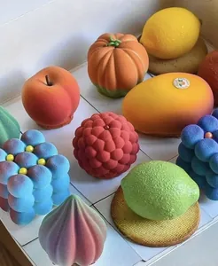 Macro view of hyper-realistic fruit-shaped mousse cakes with fine velvet textures.