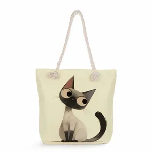 High-quality detail view of canvas tote bag featuring a cute cartoon Siamese cat print