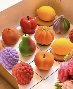 Close-up of various fruit-shaped mousse cakes with velvet texture in a grid gift box
