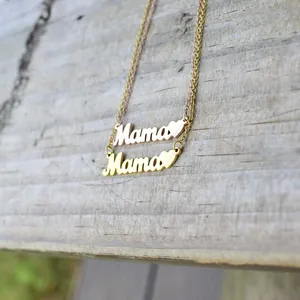 Elegant gold and rose gold Mama letter necklaces with heart charm on rustic wood