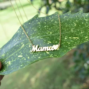Detailed view of gold titanium steel necklace with 'Mama' pendant and heart on a leaf