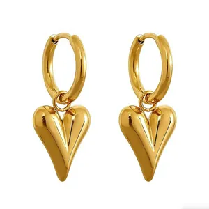 Detailed macro view of elegant gold-plated heart-shaped hoop earrings for women.