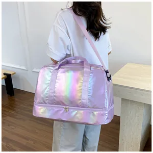 Model carrying a large iridescent purple gym bag with dry wet separation detail