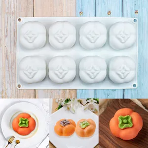 Detailed view of 8-cavity fruit shaped silicone mold with finished persimmon mousse cakes.