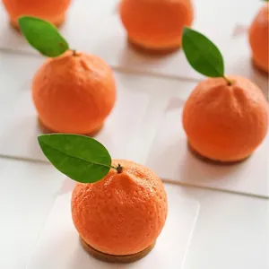Close-up of realistic orange fruit mousse cake showing detailed skin texture and green leaf