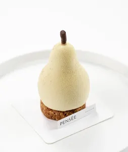 Detailed view of a realistic pear-shaped mousse cake created using a silicone mold
