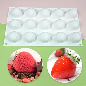 Detailed view of a 15-cavity strawberry silicone mold with finished red mousse desserts