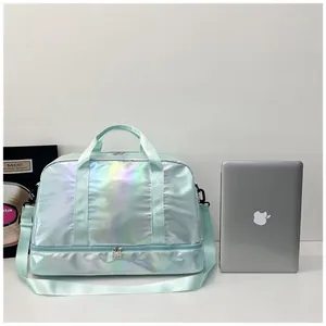 Large iridescent gym bag with wet dry compartment shown next to a laptop for size.