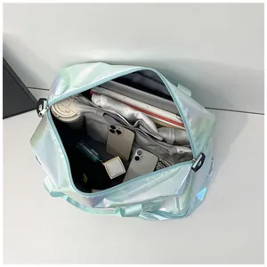 Top-down detail of iridescent travel bag showing spacious interior and compartments