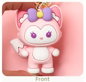 Close-up detail of a cute pink LinaBell fox keychain charm with a purple bow accessory