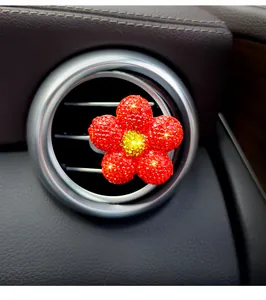 Sparkling red rhinestone flower car air vent clip diffuser installed on car vent detail