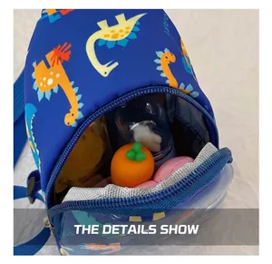 Detailed view showing the internal capacity of the kids' blue dinosaur crossbody bag