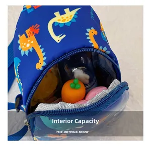 Detailed view showing the internal capacity of the kids' blue dinosaur crossbody bag