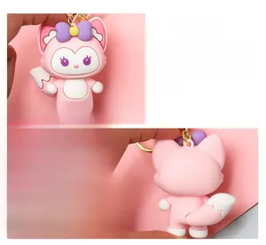 Front and back detailed views of a cute pink cartoon fox keychain with a purple bow
