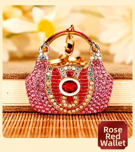 Close-up of a sparkling rose red rhinestone handbag-shaped luxury car keychain pendant