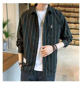 Detail view of men's loose dark green striped shirt in vintage Hong Kong style
