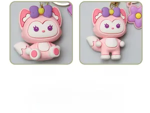 Close-up of pink fox keychains with purple bows in two cute poses.
