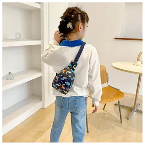 Back view of a child wearing a colorful cartoon dinosaur pattern chest bag