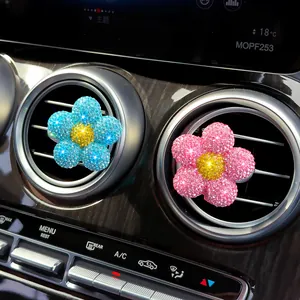 Sparkling rhinestone flower car air vent aromatherapy clips in a luxury car interior