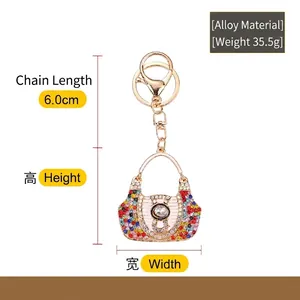 Dainty alloy keychain featuring a colorful rhinestone handbag pendant with a gold hook