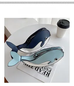Close-up view of two whale-shaped cartoon crossbody bags in blue and white color.