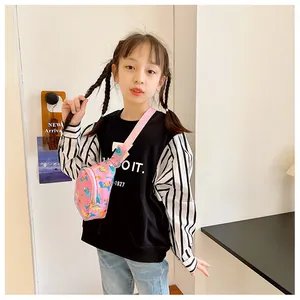 Young girl wearing a cute pink dinosaur print chest bag for an outdoor casual style
