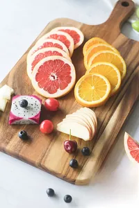 Premium acacia wood serving tray used as a vibrant fruit platter for a detail view