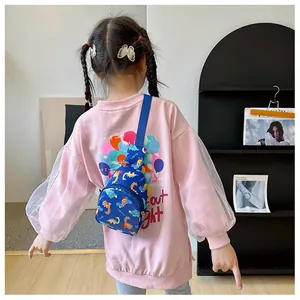 Back view of a child wearing a blue crossbody chest bag with cute cartoon dinosaur patterns
