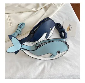 Close-up detail of two cute cartoon whale-shaped crossbody bags in blue and light blue
