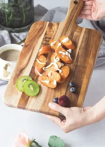 Handcrafted acacia wood serving board with food, lifestyle shot of a wooden tray